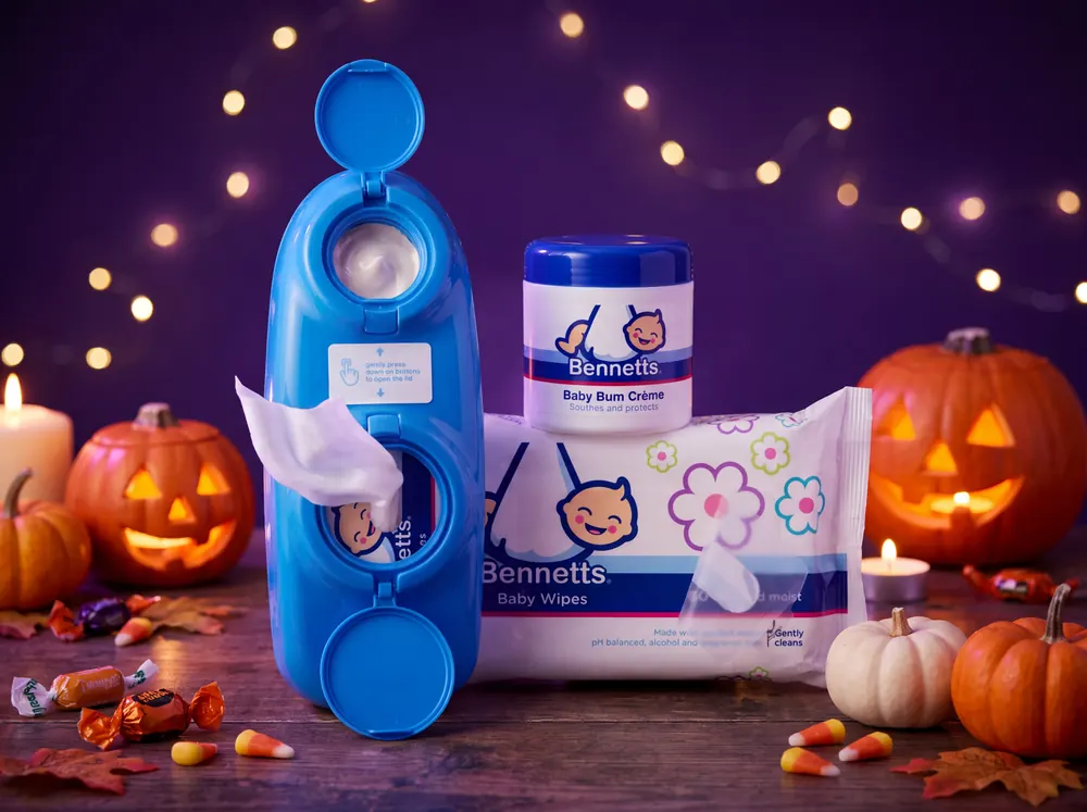 A Bennetts Bum Buddy, a tub of Baby Bum Crème and a pack of Baby Wipes with pumpkins and candy corn